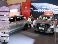 People view cars at the 16th Shandong International Auto Show in Qingdao, China, on December 13, 2024. (