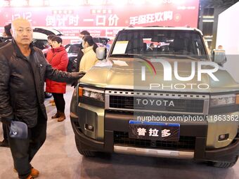 People view cars at the 16th Shandong International Auto Show in Qingdao, China, on December 13, 2024. (