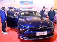 People view cars at the 16th Shandong International Auto Show in Qingdao, China, on December 13, 2024. (