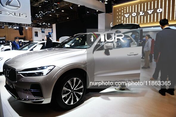 People view cars at the 16th Shandong International Auto Show in Qingdao, China, on December 13, 2024. 