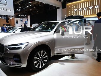 People view cars at the 16th Shandong International Auto Show in Qingdao, China, on December 13, 2024. (