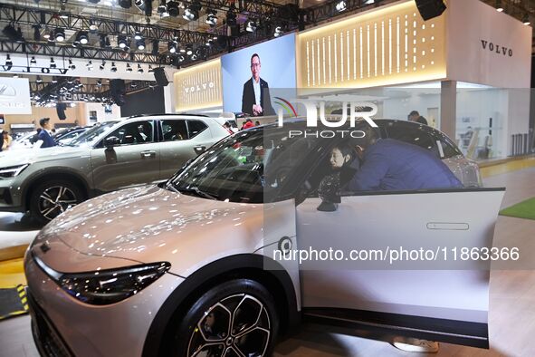 People view cars at the 16th Shandong International Auto Show in Qingdao, China, on December 13, 2024. 