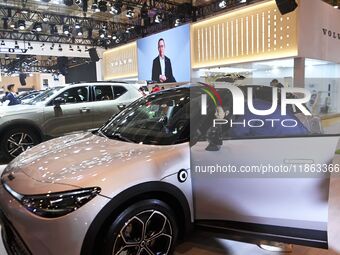 People view cars at the 16th Shandong International Auto Show in Qingdao, China, on December 13, 2024. (