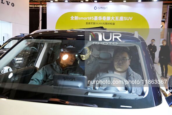 People view cars at the 16th Shandong International Auto Show in Qingdao, China, on December 13, 2024. 