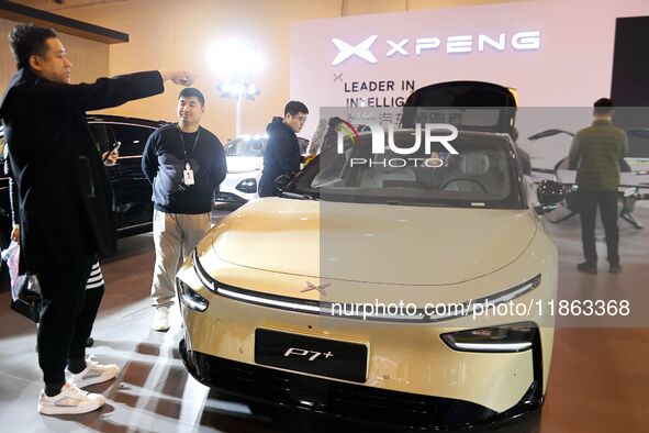 People view cars at the 16th Shandong International Auto Show in Qingdao, China, on December 13, 2024. 