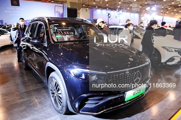 People view cars at the 16th Shandong International Auto Show in Qingdao, China, on December 13, 2024. 