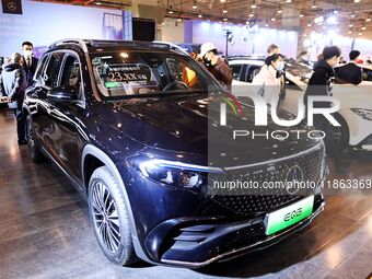 People view cars at the 16th Shandong International Auto Show in Qingdao, China, on December 13, 2024. (