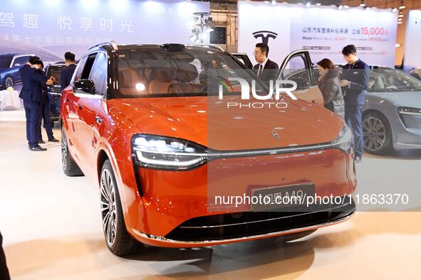 People view cars at the 16th Shandong International Auto Show in Qingdao, China, on December 13, 2024. 