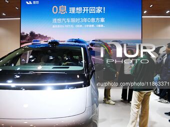 People view cars at the 16th Shandong International Auto Show in Qingdao, China, on December 13, 2024. (