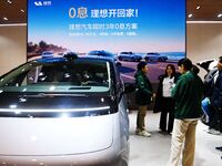 People view cars at the 16th Shandong International Auto Show in Qingdao, China, on December 13, 2024. (