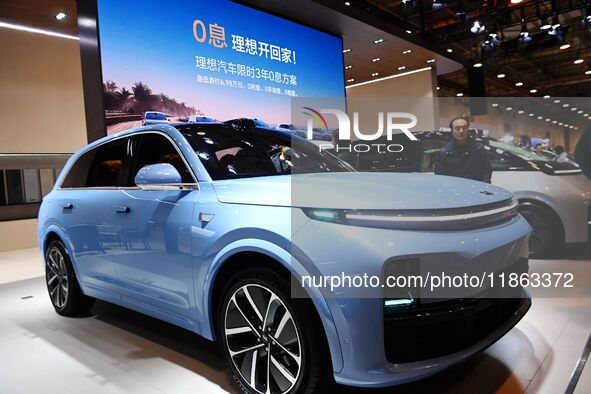 People view cars at the 16th Shandong International Auto Show in Qingdao, China, on December 13, 2024. 