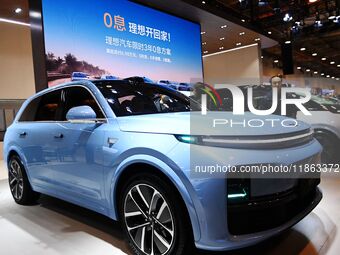 People view cars at the 16th Shandong International Auto Show in Qingdao, China, on December 13, 2024. (