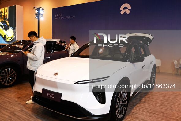 People view cars at the 16th Shandong International Auto Show in Qingdao, China, on December 13, 2024. 