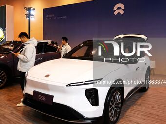 People view cars at the 16th Shandong International Auto Show in Qingdao, China, on December 13, 2024. (