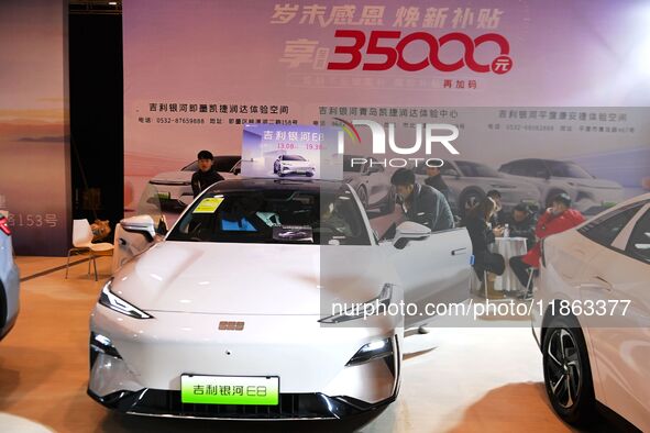 People view cars at the 16th Shandong International Auto Show in Qingdao, China, on December 13, 2024. 