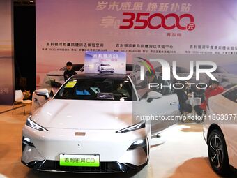 People view cars at the 16th Shandong International Auto Show in Qingdao, China, on December 13, 2024. (