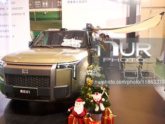 People view cars at the 16th Shandong International Auto Show in Qingdao, China, on December 13, 2024. (