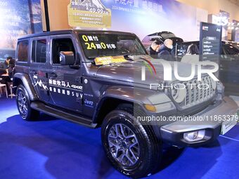 People view cars at the 16th Shandong International Auto Show in Qingdao, China, on December 13, 2024. (