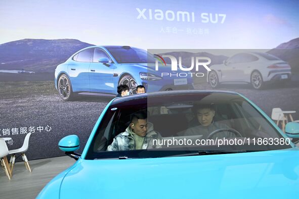 People view cars at the 16th Shandong International Auto Show in Qingdao, China, on December 13, 2024. 