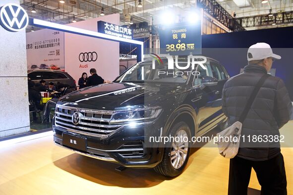 People view cars at the 16th Shandong International Auto Show in Qingdao, China, on December 13, 2024. 