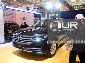 People view cars at the 16th Shandong International Auto Show in Qingdao, China, on December 13, 2024. (