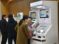 A staff member instructs residents to handle business using smart terminals of government affairs services at the Yongnian District governme...