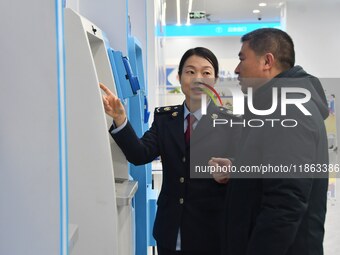 Tax officers guide residents to handle tax-related business at the tax service hall of Yongnian District Government Affairs Service Center i...