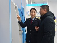 Tax officers guide residents to handle tax-related business at the tax service hall of Yongnian District Government Affairs Service Center i...