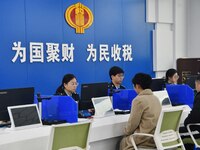 Tax officers handle business for taxpayers at the tax service hall of Yongnian District Government Affairs Service Center in Handan, North C...