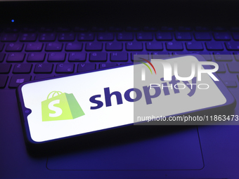 The Shopify logo appears on the screen of a smartphone in Reno, United States, on December 12, 2024 (