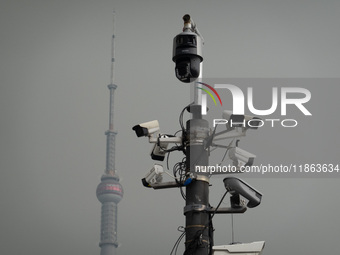 Security cameras are on a pole near the Bund Square in Shanghai, China, on December 13, 2024. (