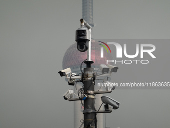 Security cameras are on a pole near the Bund Square in Shanghai, China, on December 13, 2024. (