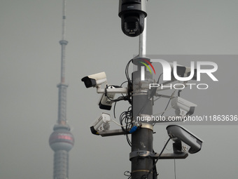 Security cameras are on a pole near the Bund Square in Shanghai, China, on December 13, 2024. (