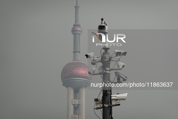 Security cameras are on a pole near the Bund Square in Shanghai, China, on December 13, 2024. 