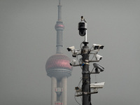 Security cameras are on a pole near the Bund Square in Shanghai, China, on December 13, 2024. (