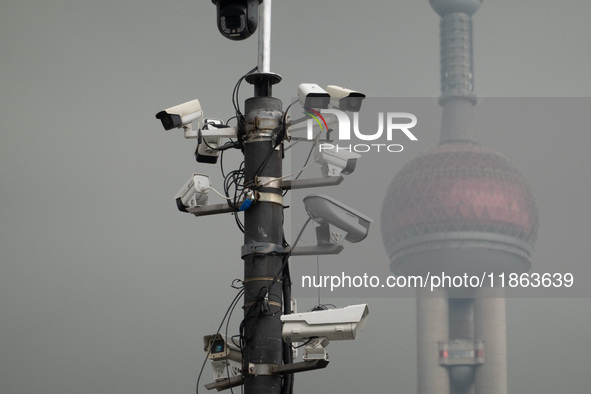 Security cameras are on a pole near the Bund Square in Shanghai, China, on December 13, 2024. 