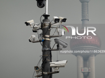 Security cameras are on a pole near the Bund Square in Shanghai, China, on December 13, 2024. (