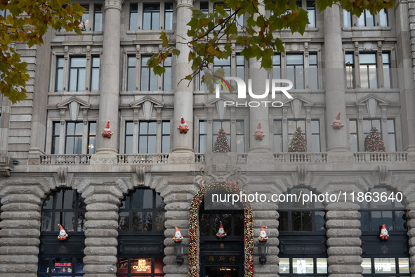 Santa Claus decorations are seen on the exterior wall of Roosevelt Residence on the Bund in Shanghai, China, on December 13, 2024. 