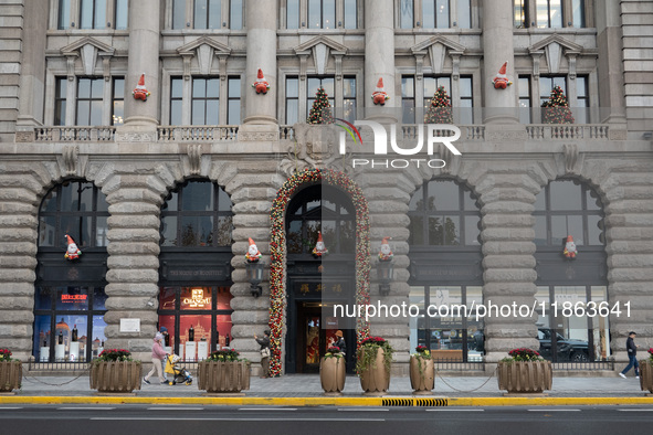 Santa Claus decorations are seen on the exterior wall of Roosevelt Residence on the Bund in Shanghai, China, on December 13, 2024. 