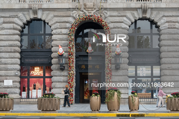 Santa Claus decorations are seen on the exterior wall of Roosevelt Residence on the Bund in Shanghai, China, on December 13, 2024. 