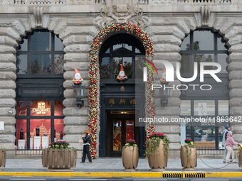 Santa Claus decorations are seen on the exterior wall of Roosevelt Residence on the Bund in Shanghai, China, on December 13, 2024. (