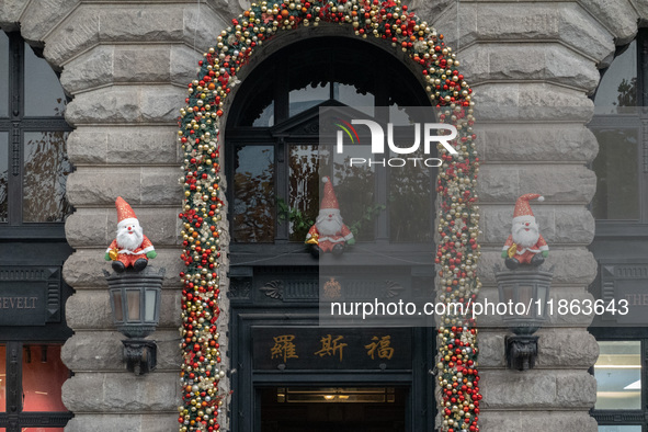 Santa Claus decorations are seen on the exterior wall of Roosevelt Residence on the Bund in Shanghai, China, on December 13, 2024. 