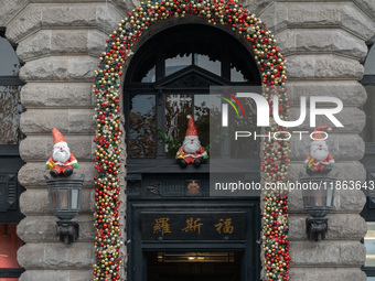 Santa Claus decorations are seen on the exterior wall of Roosevelt Residence on the Bund in Shanghai, China, on December 13, 2024. (