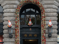 Santa Claus decorations are seen on the exterior wall of Roosevelt Residence on the Bund in Shanghai, China, on December 13, 2024. (