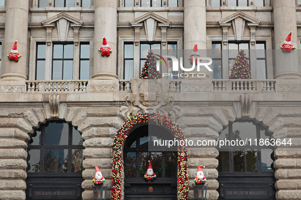 Santa Claus decorations are seen on the exterior wall of Roosevelt Residence on the Bund in Shanghai, China, on December 13, 2024. 