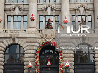 Santa Claus decorations are seen on the exterior wall of Roosevelt Residence on the Bund in Shanghai, China, on December 13, 2024. (