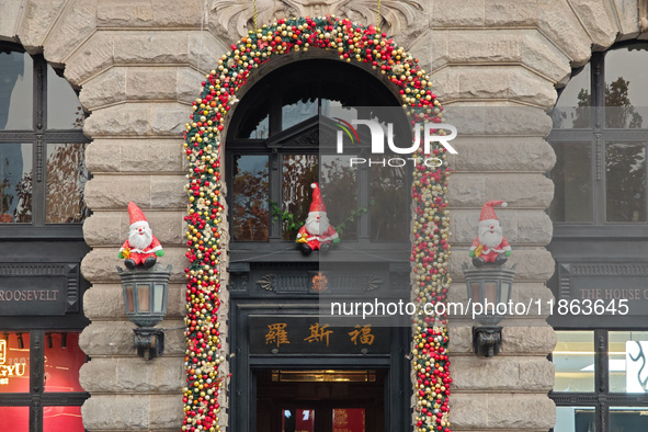 Santa Claus decorations are seen on the exterior wall of Roosevelt Residence on the Bund in Shanghai, China, on December 13, 2024. 