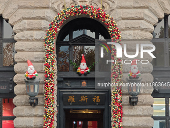 Santa Claus decorations are seen on the exterior wall of Roosevelt Residence on the Bund in Shanghai, China, on December 13, 2024. (