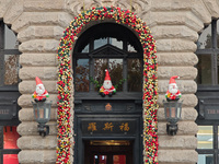 Santa Claus decorations are seen on the exterior wall of Roosevelt Residence on the Bund in Shanghai, China, on December 13, 2024. (