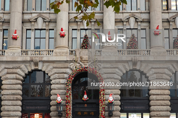 Santa Claus decorations are seen on the exterior wall of Roosevelt Residence on the Bund in Shanghai, China, on December 13, 2024. 